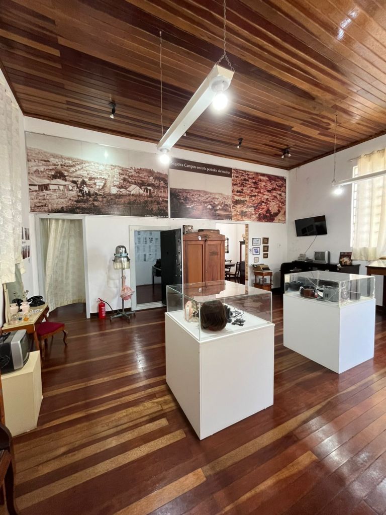Sala expositiva com vitrines e fotografias históricas